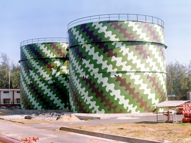 Camouflaged oil storage tanks